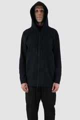 Nomen Nescio - Front hood view of black raglan zip hoodie with wool rib cuffs, relaxed fit.