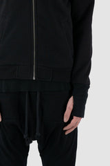 Obectra Studio - Front hem view of Black Cotton Nalla Sweat Bomber Jacket with thumbhole details, slim fit, Permanent Collection.