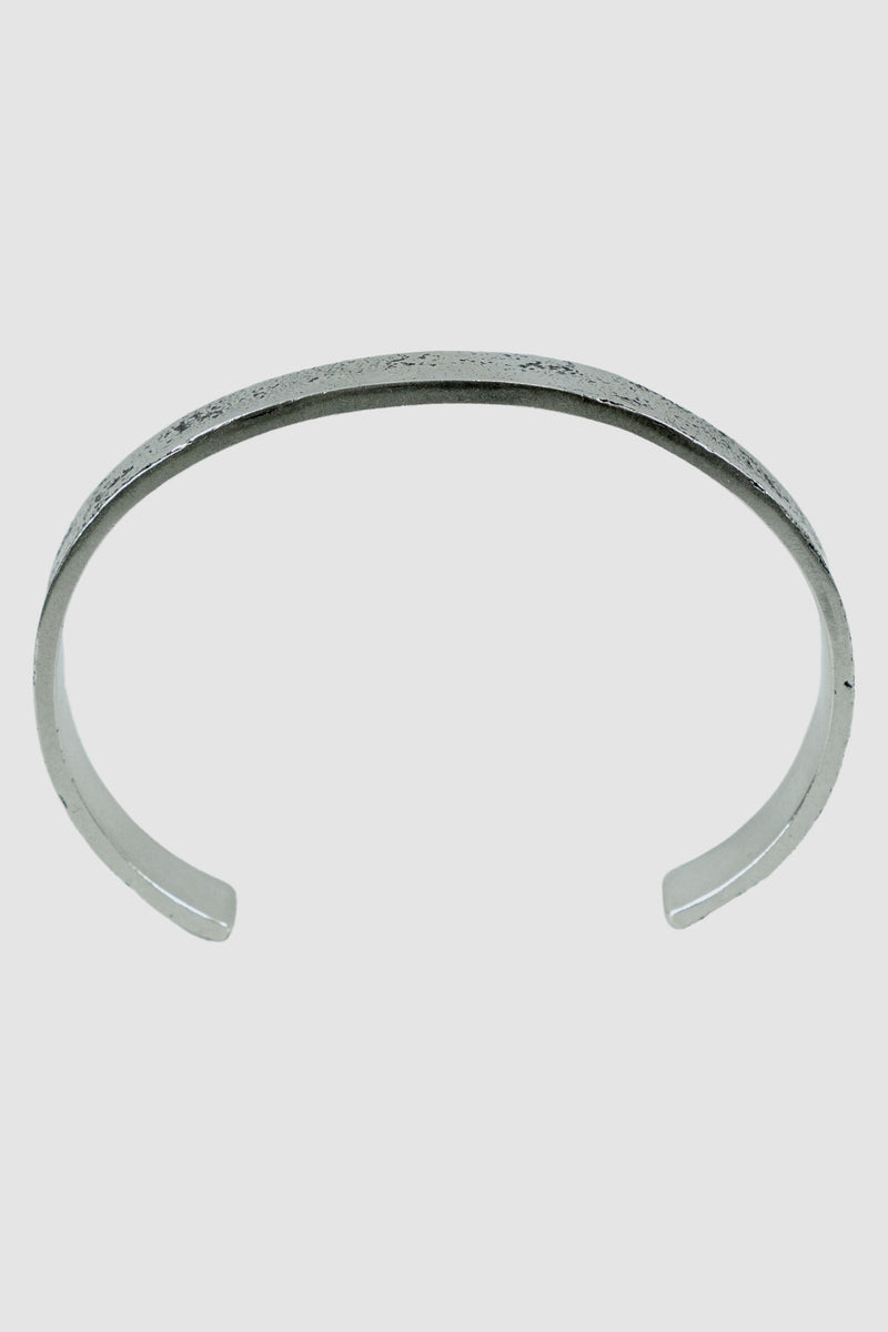 OLIVIER 925 silver open cuff from the Permanent Collection, featuring an irregular outer surface and minimalist bracelet design, stand alone view.