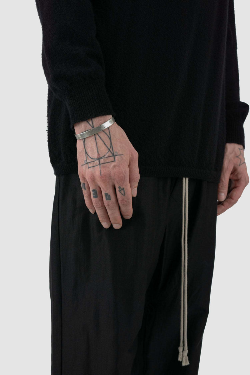 OLIVIER 925 silver open cuff from the Permanent Collection, featuring an irregular outer surface and minimalist bracelet design on person.