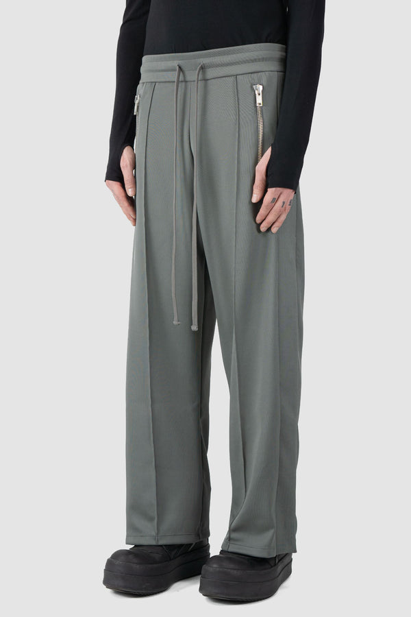 Ovnnie - side view of the stone grey Push Button Track Pants.