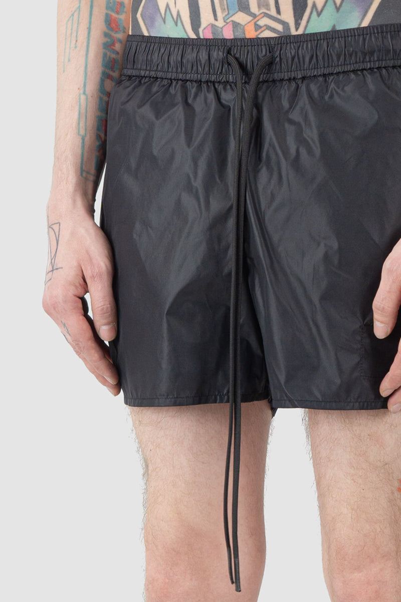 Ovnnie - detail view of the black Swim Trunks.