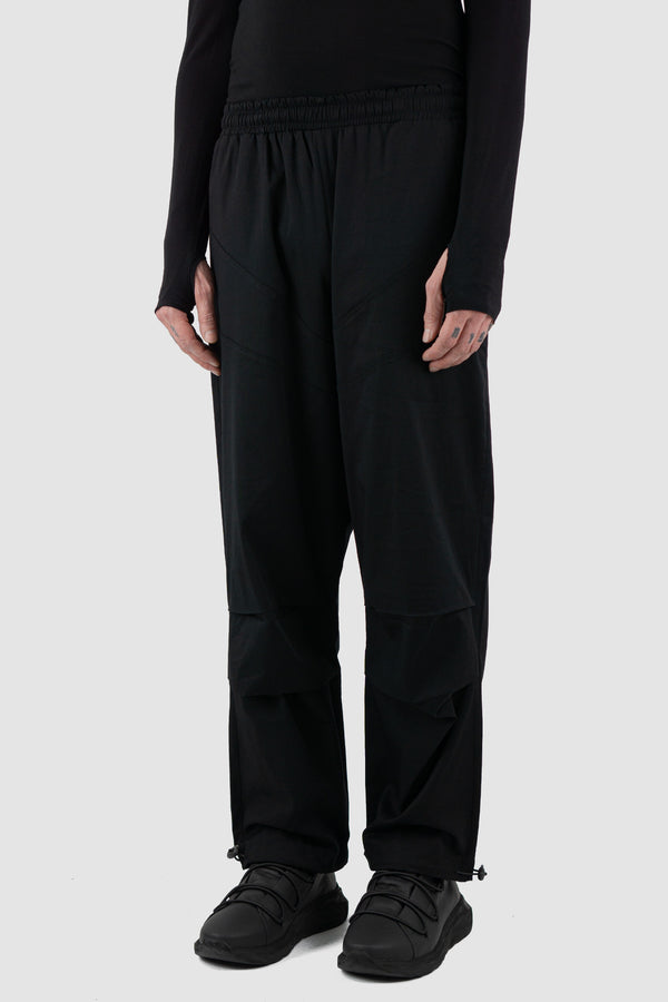 Side view of Black Parachute Cotton Pants for Men with adjustable hem, LA HAINE INSIDE US