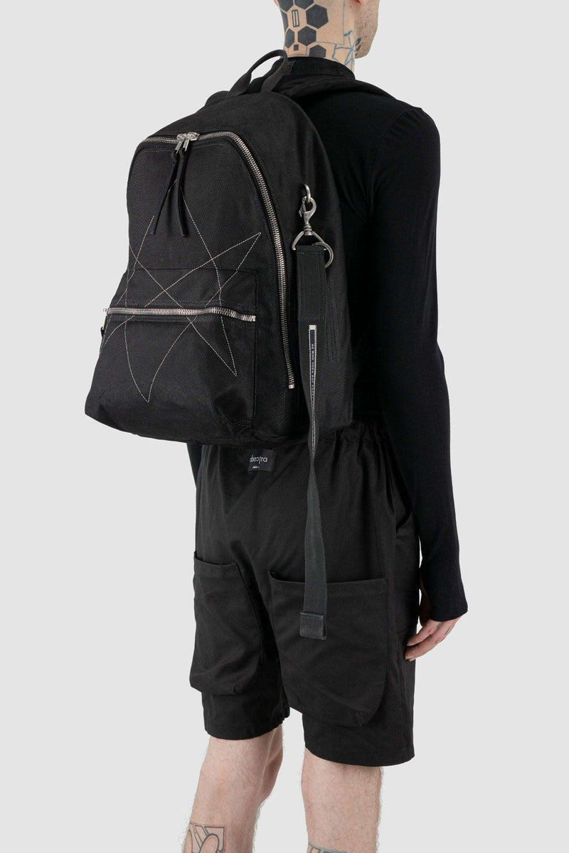 Rick Owens DRKSHDW Black Cotton Backpack with Embroidered Pentagram Logo. Perfect for laptops, with an extra keychain on Person.