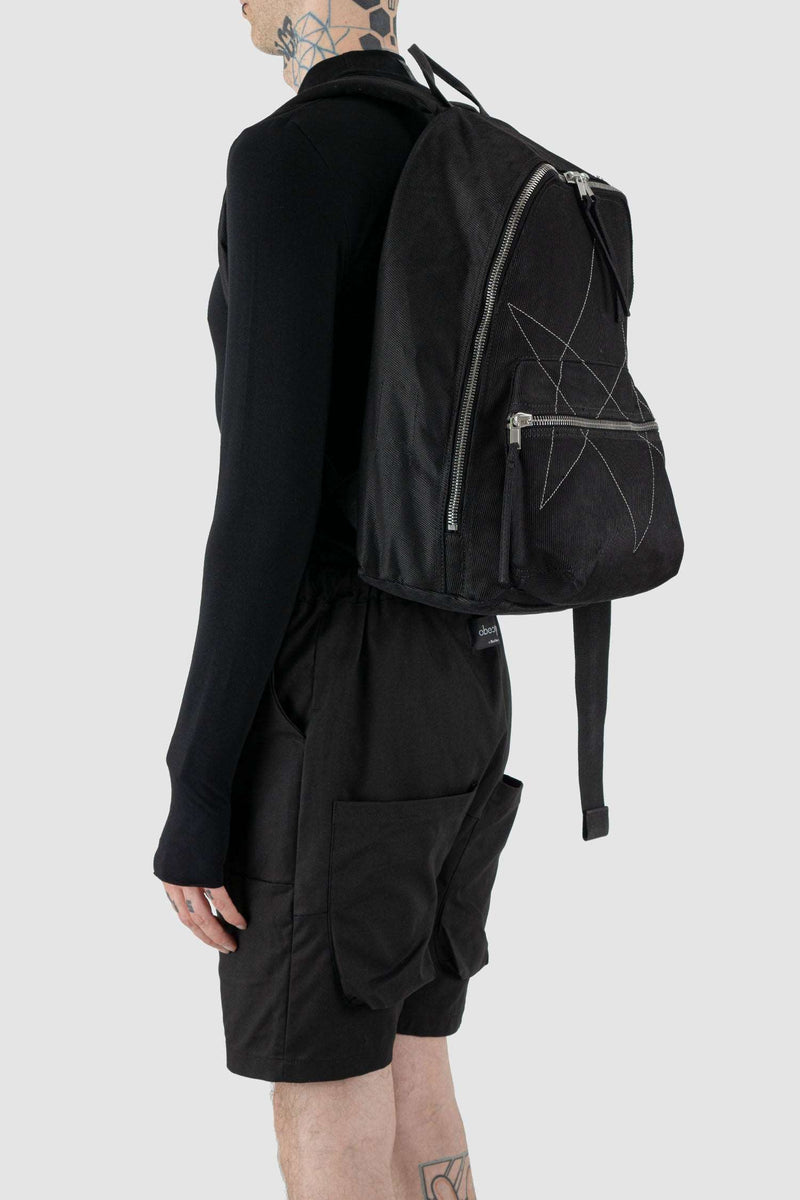 Rick Owens DRKSHDW Black Cotton Backpack with Embroidered Pentagram Logo. Perfect for laptops, with an extra keychain on Person left.