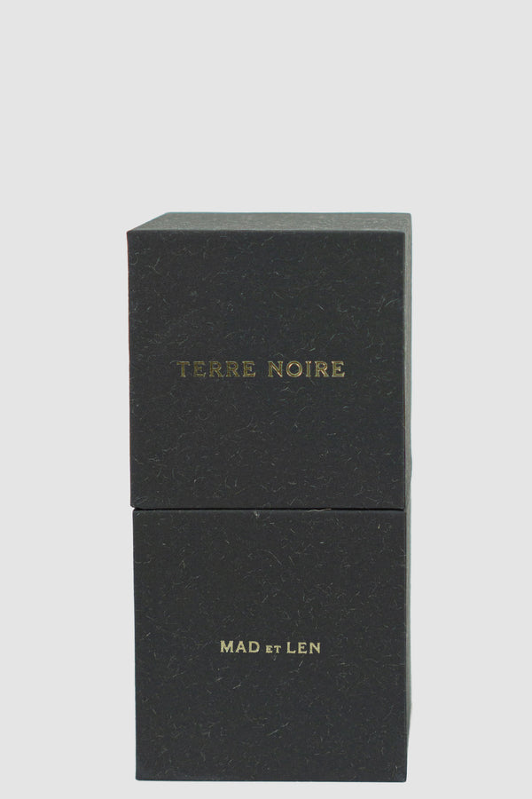 MAD ET LEN Terre Noire Scent Eau de Parfum: Sealed in recycled paper box. | Material: 100% Alcohol | Notes: Vetyver, Cedre, Bergamote, Patchouli | 50 ml Version | Made in France.