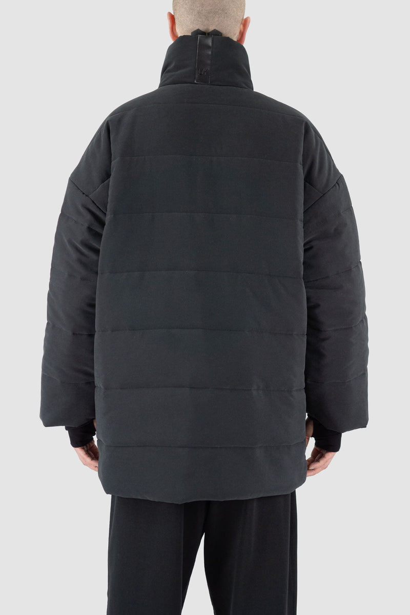 UY Studio - back view of black big puffer coat with big patch stitched pockets.