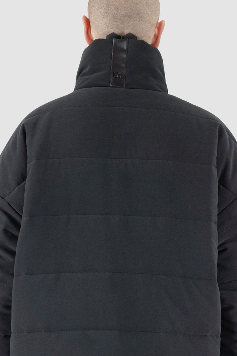 UY Studio - back detail view of black big puffer coat with big patch stitched pockets.