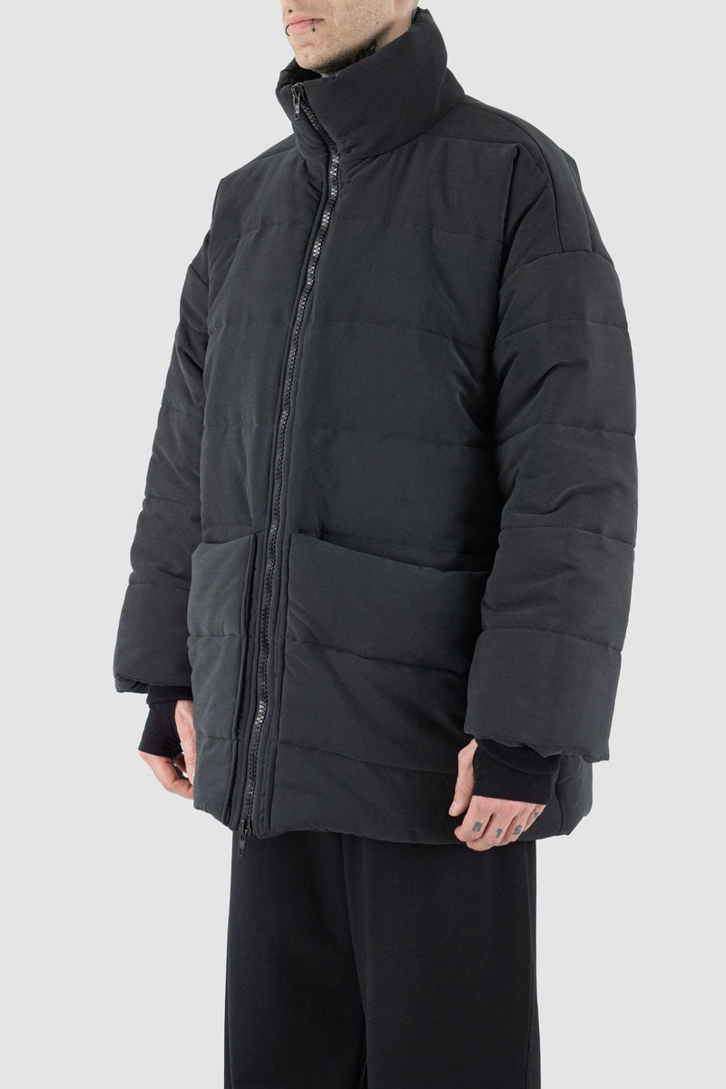 UY Studio - Side view of black big puffer coat.