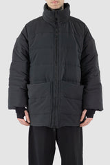 UY Studio - Front view of black big puffer coat with big patch stitched pockets.