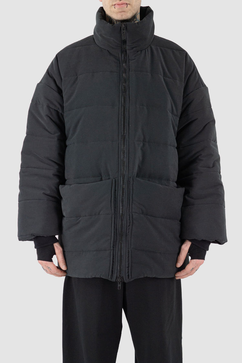 UY Studio - Front view of black big puffer coat with big patch stitched pockets.