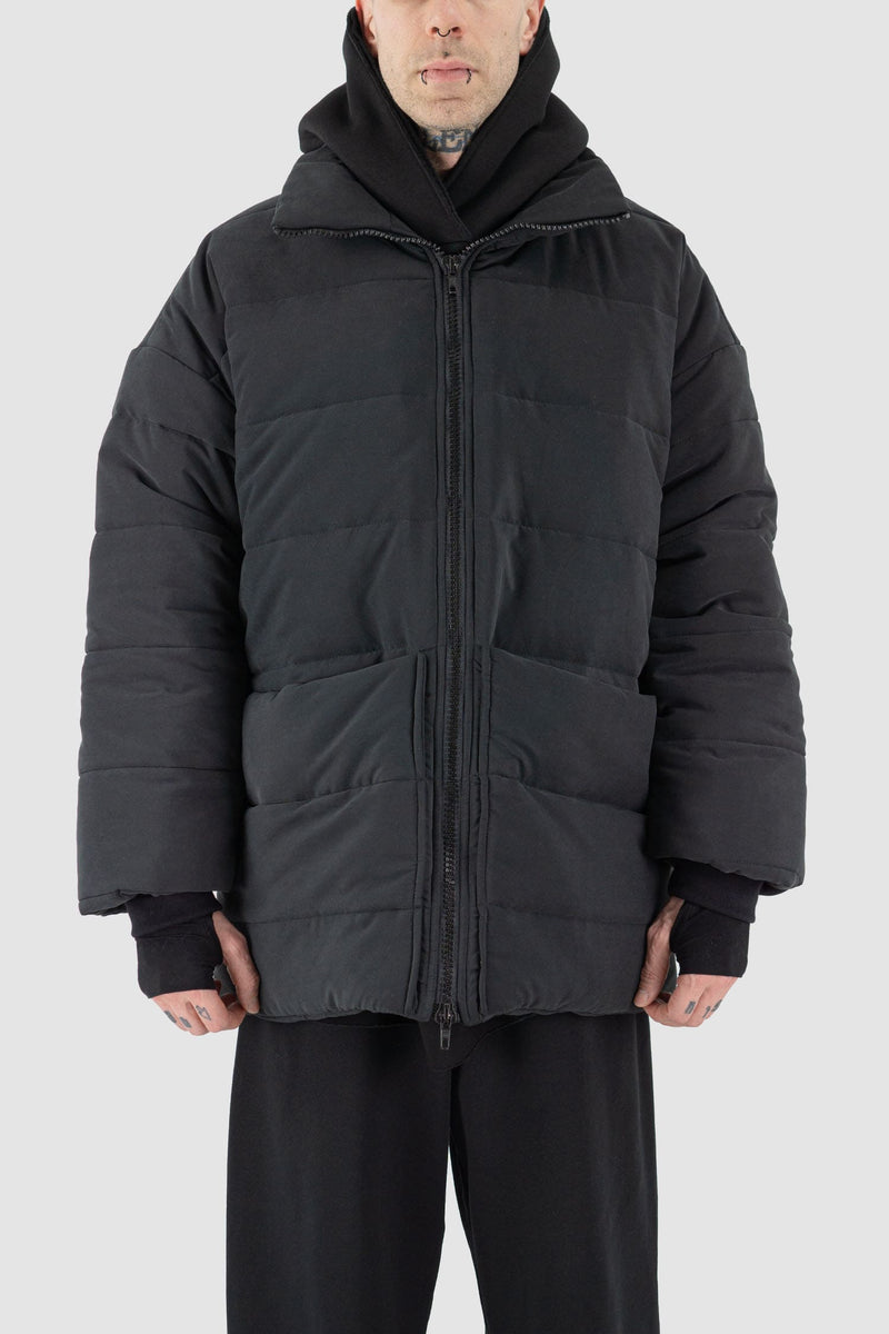 UY Studio - closed hood view of black big puffer coat with big patch stitched pockets.