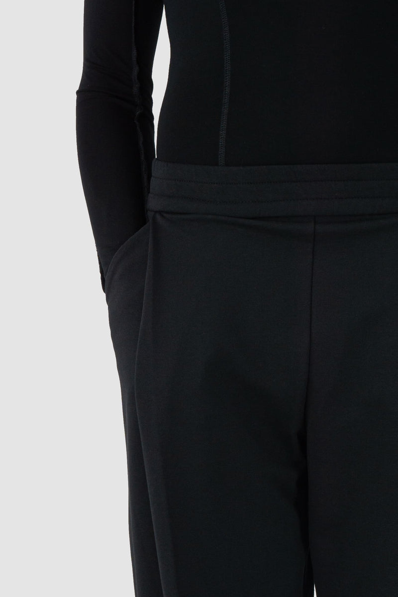 UY Studio - front pocket view of black casual jogging pants for men from the FW24 collection feature a flexible elastic waistband and leg cuffs, offering both comfort and style.