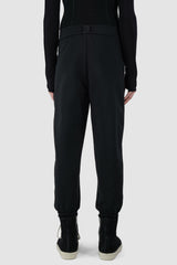 UY Studio - back view of black casual jogging pants for men from the FW24 collection feature a flexible elastic waistband and leg cuffs, offering both comfort and style.