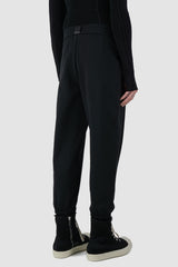 UY Studio - back side view of black casual jogging pants for men from the FW24 collection feature a flexible elastic waistband and leg cuffs, offering both comfort and style.