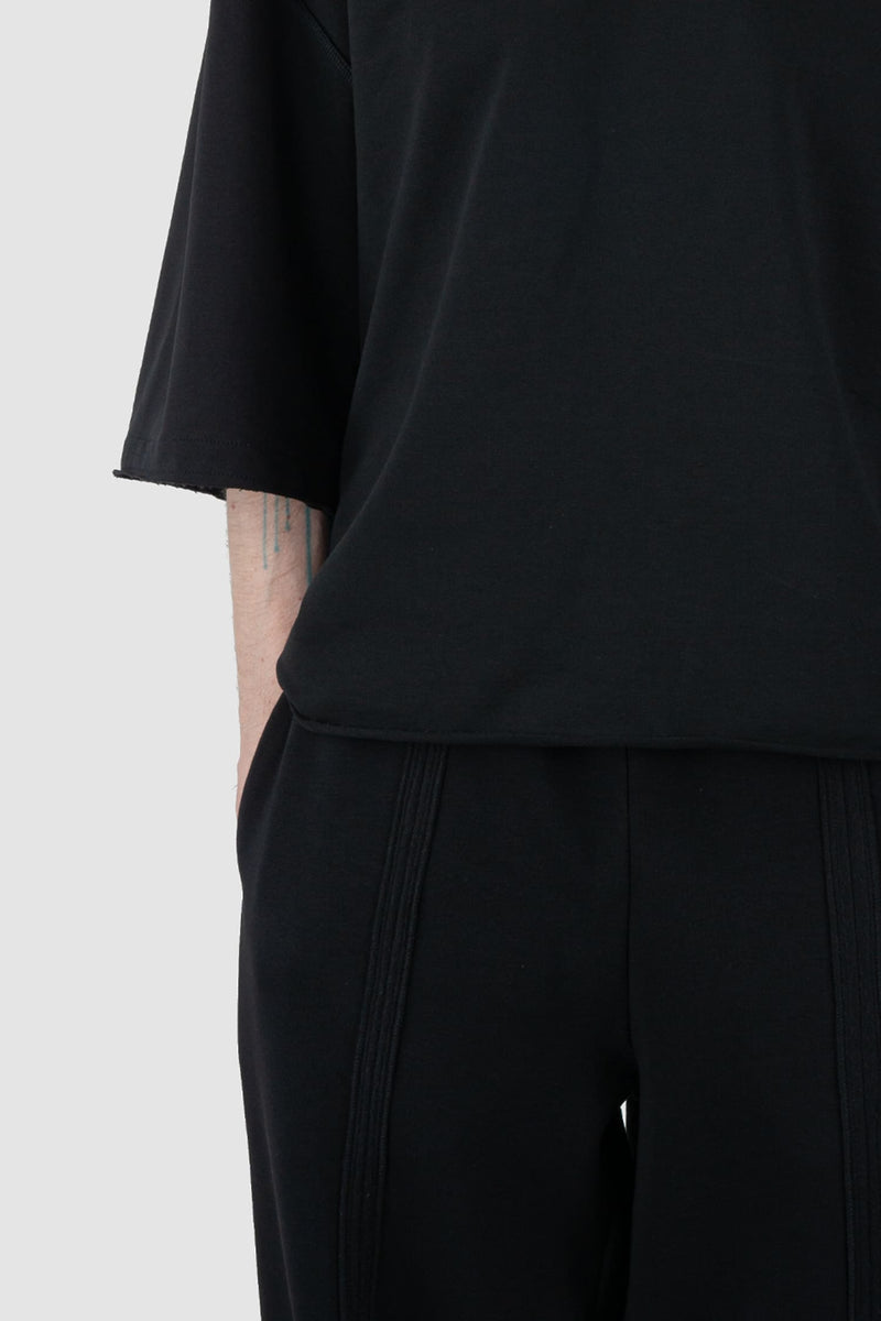 UY Studio - front hem detail view of Black Cropped Heavy Cotton T-Shirt for men from the FW24 collection features an oversized fit with extended shoulders and a close-fitting collar.