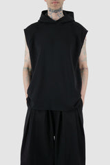 UY Studio - front relax view of black jumbo hooded tank top for men from the FW24 collection with a large, cozy hood, open end seams and made of thick, warm cotton.