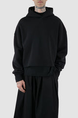 UY Studio - front relax view of black cropped big jumbo Hoodie for men from the FW24 collection with semi-raglan shoulders, raw-edge seams and loose and flared long sleeves.