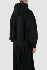 UY Studio - back side view of black cropped big jumbo Hoodie for men from the FW24 collection with semi-raglan shoulders, raw-edge seams and loose and flared long sleeves.