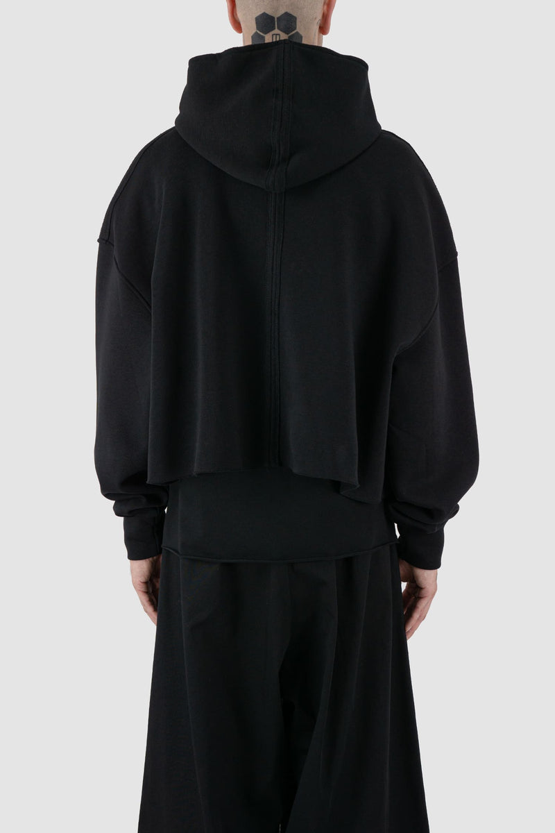 UY Studio - back view of black cropped big jumbo Hoodie for men from the FW24 collection with semi-raglan shoulders, raw-edge seams and loose and flared long sleeves.