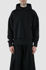 UY Studio - front view of black cropped big jumbo Hoodie for men from the FW24 collection with semi-raglan shoulders, raw-edge seams and loose and flared long sleeves.