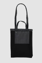 UY Studio - inside out view of black vegan leather shopper tote bag from the FW24 collection with two different straps, an inside pocket for purses and cotton lining.