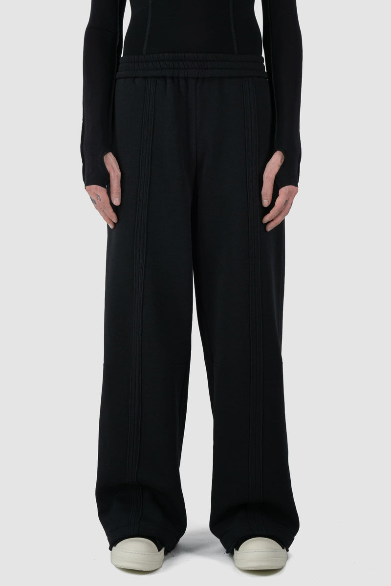 UY Studio - front view of Black Thick Cotton Wide-Leg Jogger Pants for men from the FW24 collection are crafted from warm, thick cotton, featuring a chunky elastic waistband and two double seams at the front.