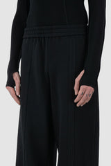 UY Studio - front waist view of Black Thick Cotton Wide-Leg Jogger Pants for men from the FW24 collection are crafted from warm, thick cotton, featuring a chunky elastic waistband and two double seams at the front.