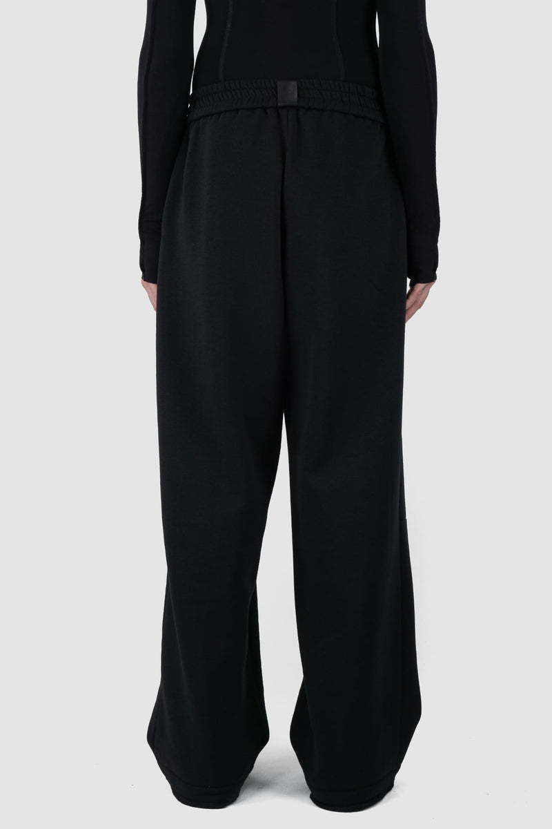 UY Studio - back view of Black Thick Cotton Wide-Leg Jogger Pants for men from the FW24 collection are crafted from warm, thick cotton, featuring a chunky elastic waistband and two double seams at the front.