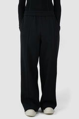 UY Studio - front relaxed view of Black Thick Cotton Wide-Leg Jogger Pants for men from the FW24 collection are crafted from warm, thick cotton, featuring a chunky elastic waistband and two double seams at the front.