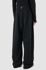 UY Studio - back view of black cotton wide leg Gangster sweatpants with elastic waistband, clean edge hem, Permanent Collection.