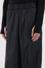 UY Studio - detail view of black nylon wide fisher pants with elastic waistband, loose fit.