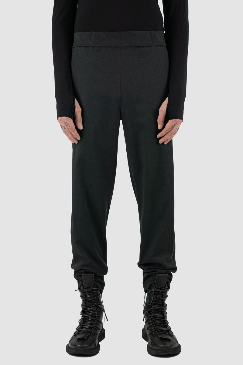 UY Studio - Front view of black Less pants with carrot cut, elastic waist, made from cotton twill, Permanent Collection.