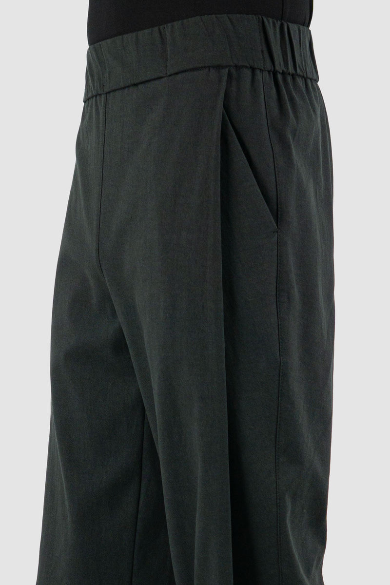 UY Studio - pocket view of black Less pants with carrot cut, elastic waist, made from cotton twill, Permanent Collection.