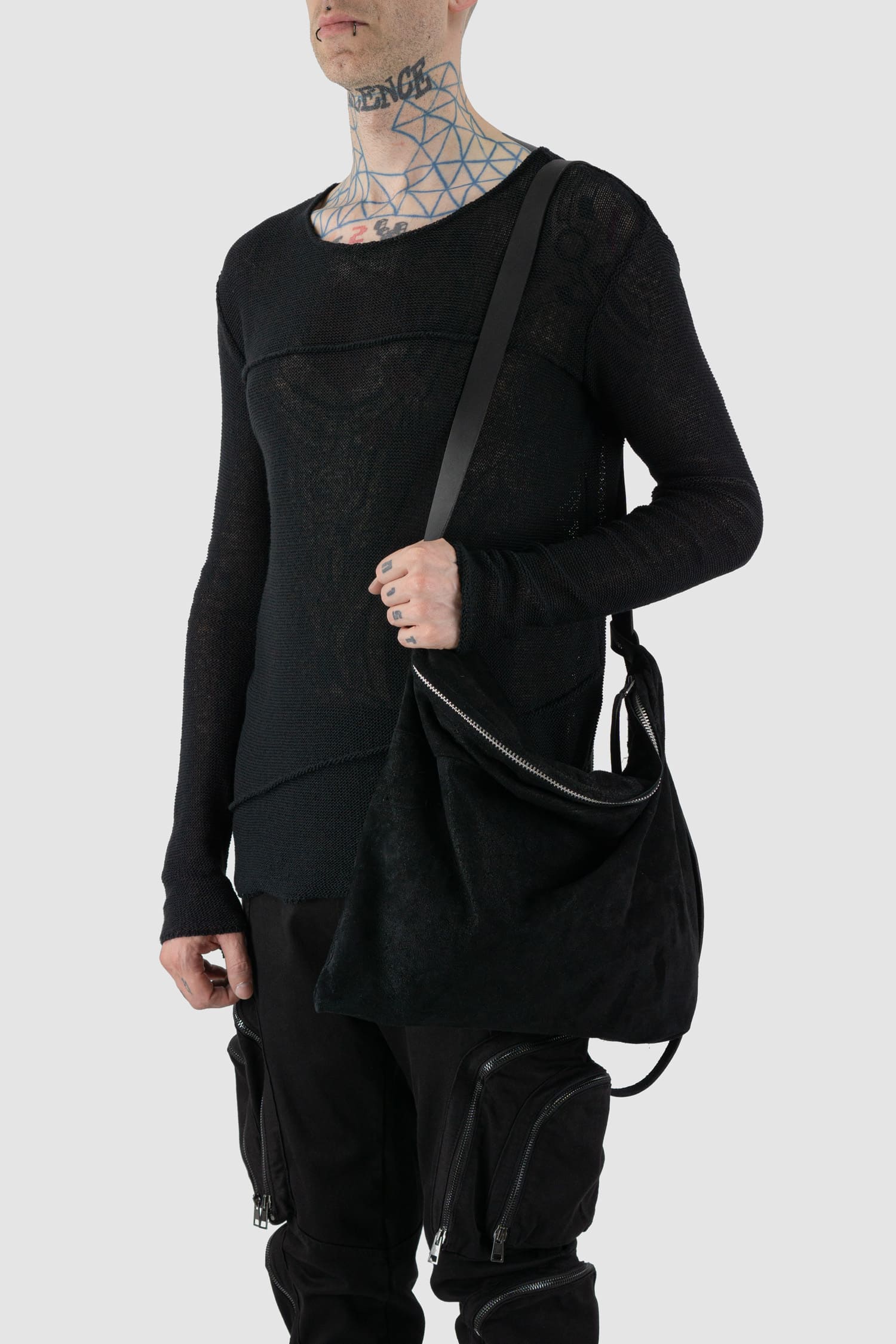 Werkschwarz - One shoulder view of black waxed reversed leather one-shoulder pack bag is the ideal piece to wear crossbody from the Permanent collection. It features a waxed finish, an origami shape, and a heavy-duty YKK zipper, combining functionality with contemporary design.