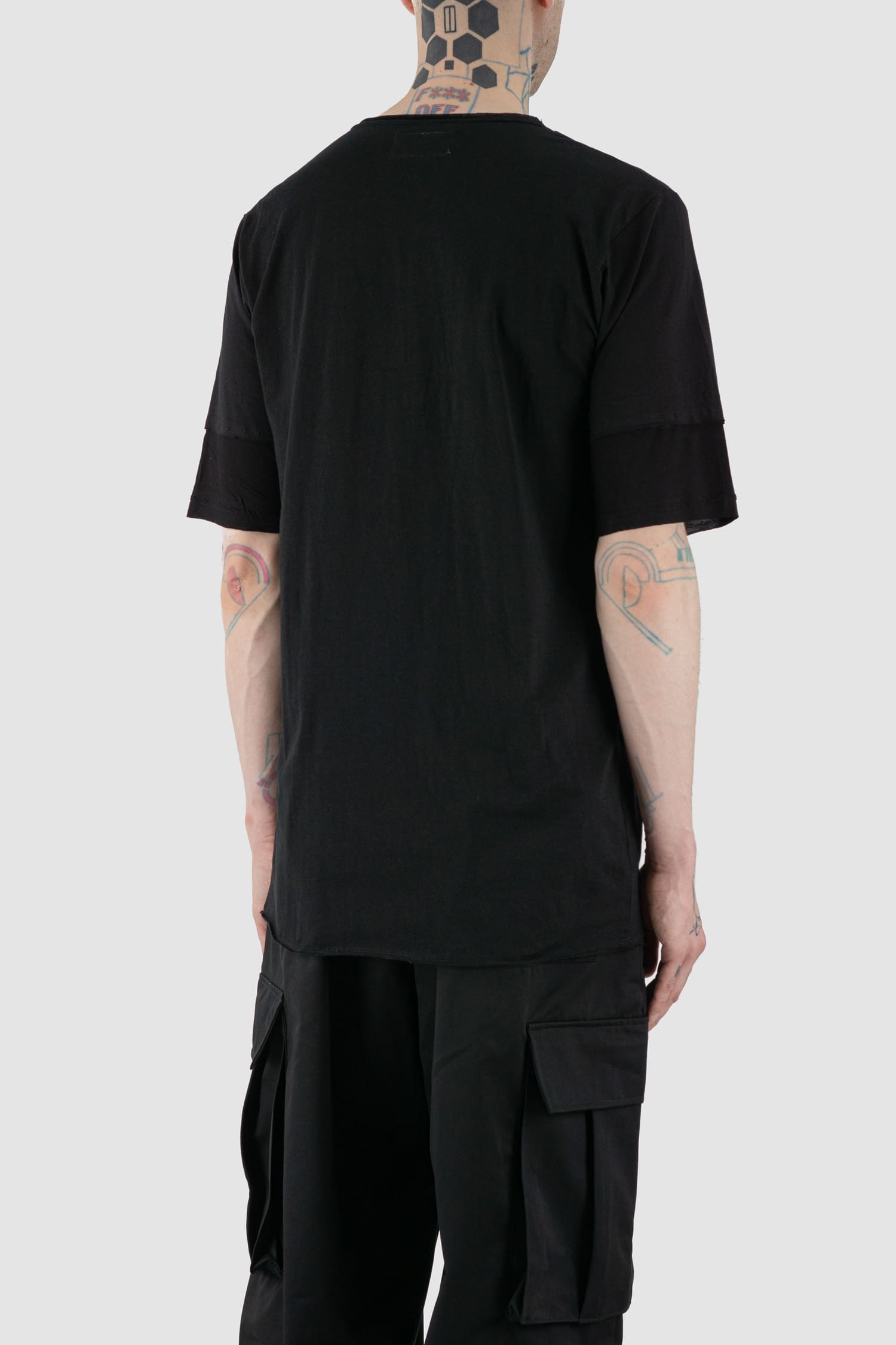 XConcept - back side view of black asymmetric pointed Tack T-shirt for men with double-layer sleeves, pointed tapered front, FW24 Collection.