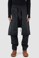 XConcept - Front view of black front panel trousers for men with decorative inserts on both sides, elasticated waistband with drawstring, FW24 Collection.