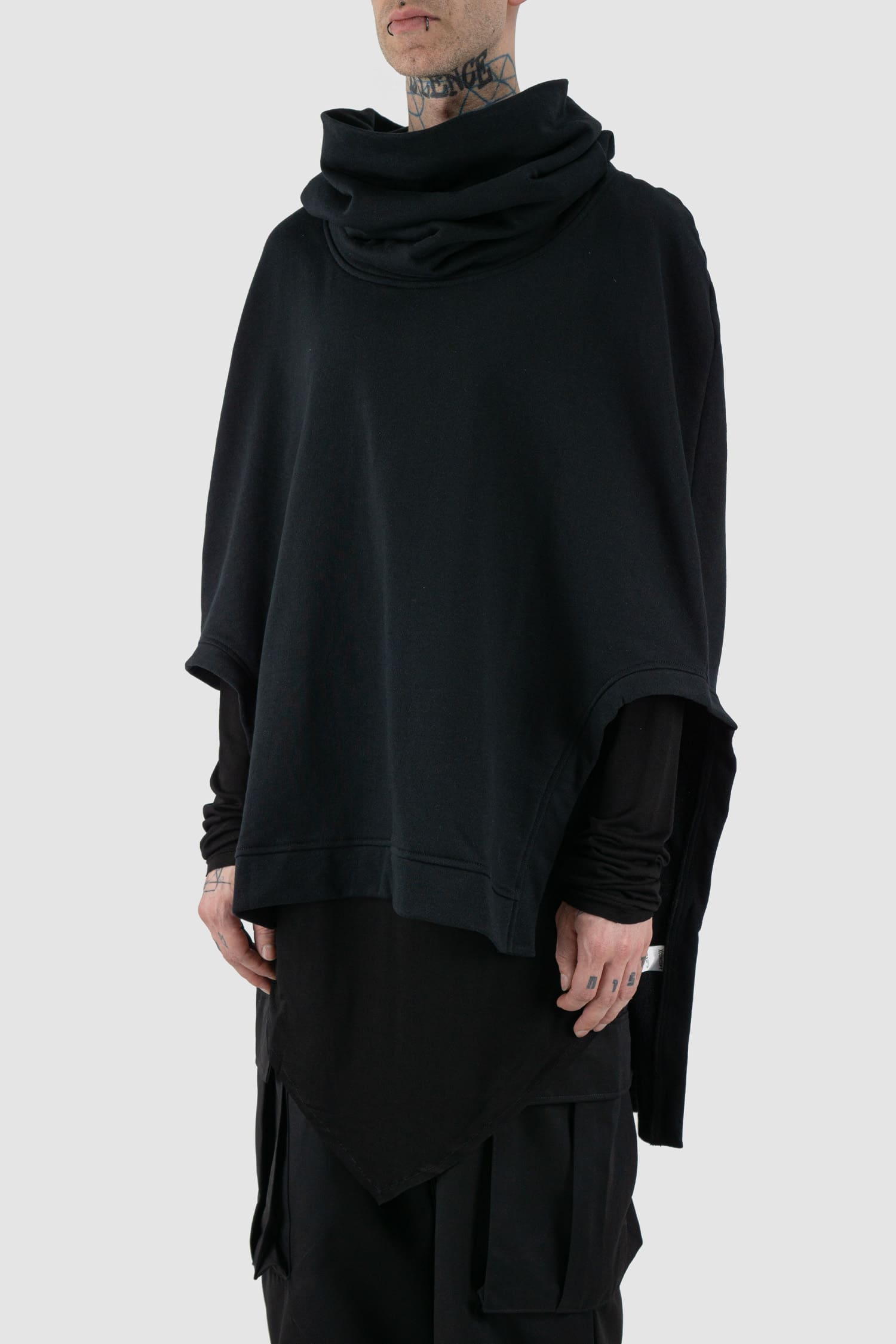 XConcept - Front side view of black overlapping shoulder high neck top.