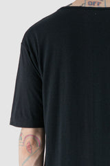 XConcept - arm detail view of black overlength bamboo T-shirt for men with side slits, round neckline, FW24 Collection.