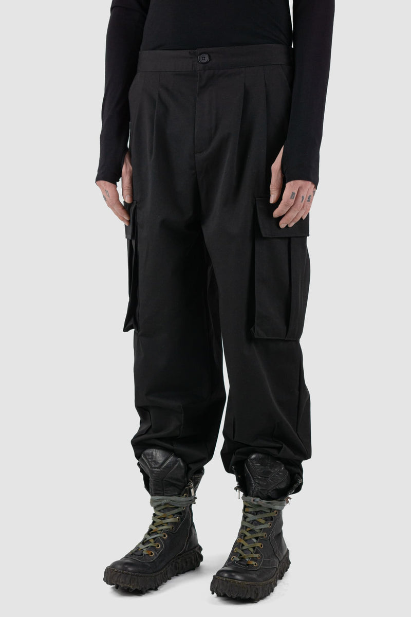 XConcept - Front side view of black shortened military cargo pants.