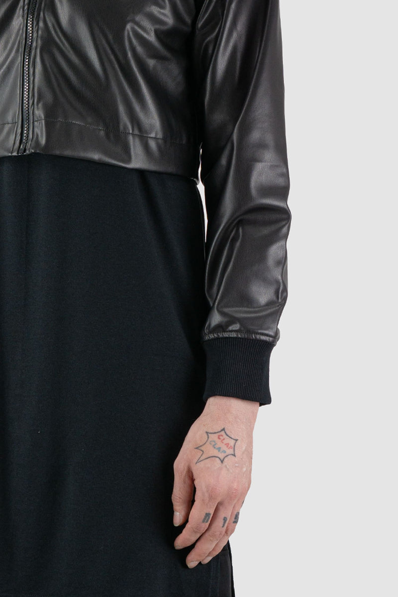 XConcept - arm view of black hooded jacket made of vegan leather for men with slightly shortened sleeves, cropped 'bolero' length, FW24 Collection.