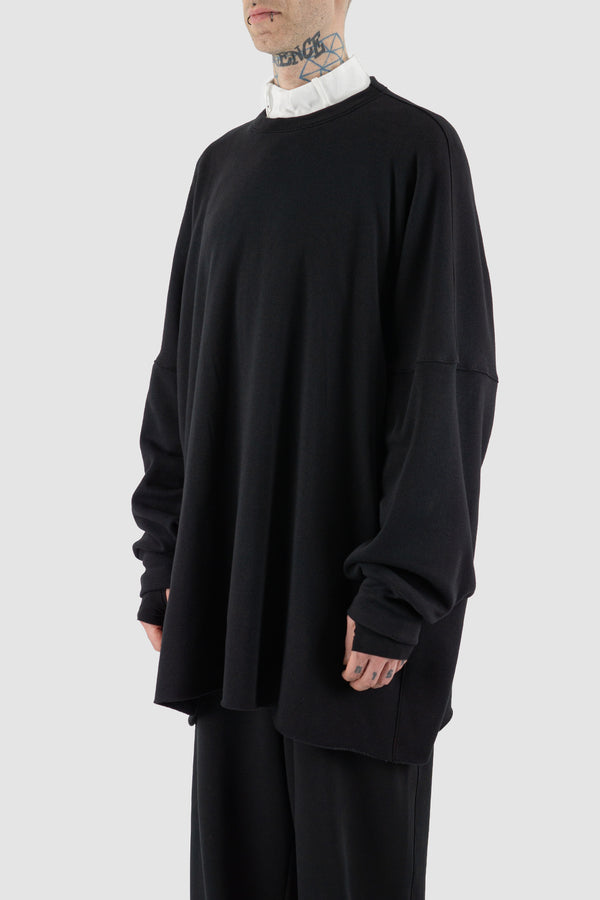 Black Heat Tech Jumbo Oversize Sweater by UY STUDIO. Loose fit, composed of 65%PL and 35% Cotton. Features raw-edged bottom, square cut, and pleated double-layered cuffs. Visible vegan Leather UY Label on the back. Made in Germany.