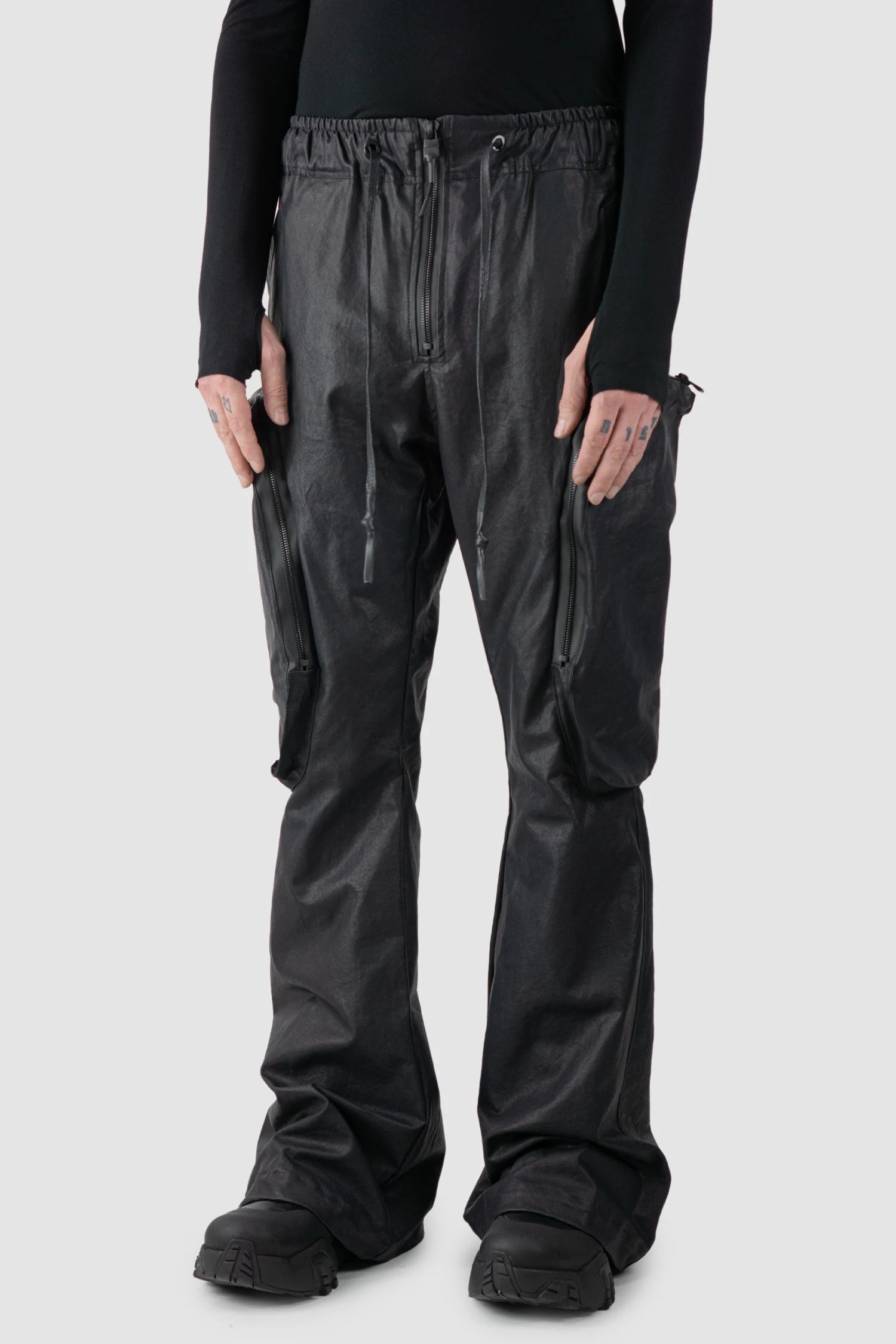 Gall Laboratories by Justin Gall - model front side view of men’s Black Heavy Coated Wide Leg Cargo Trousers