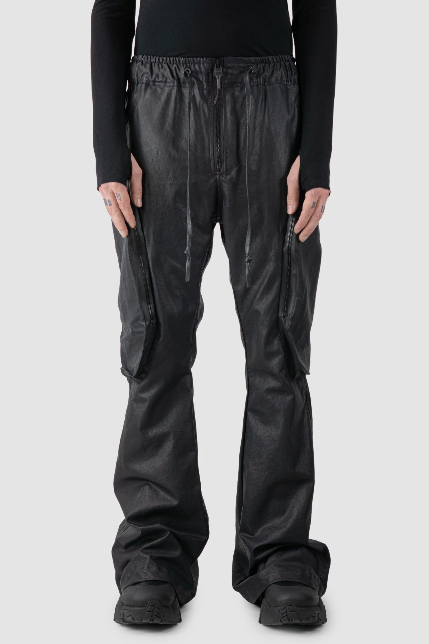 Gall Laboratories by Justin Gall - model front view of men’s Black Heavy Coated Wide Leg Cargo Trousers