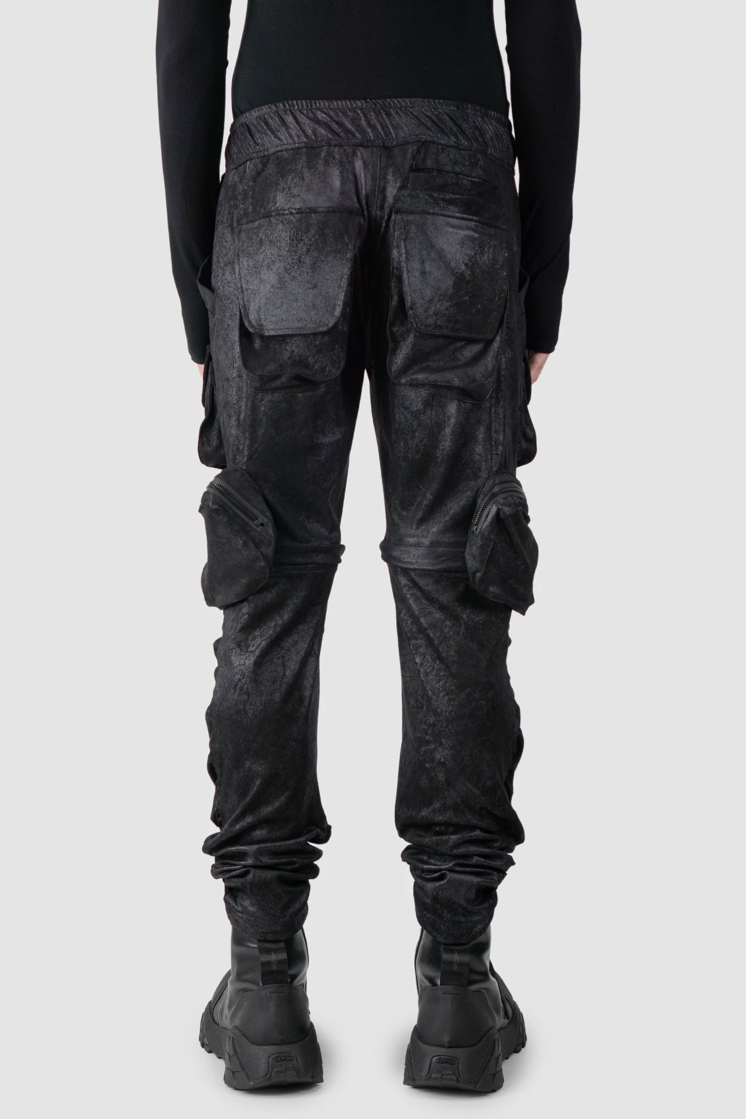 Gall Laboratories by Justin Gall - model back view of men’s Black Vegan Leather Convertible Cargo Trousers