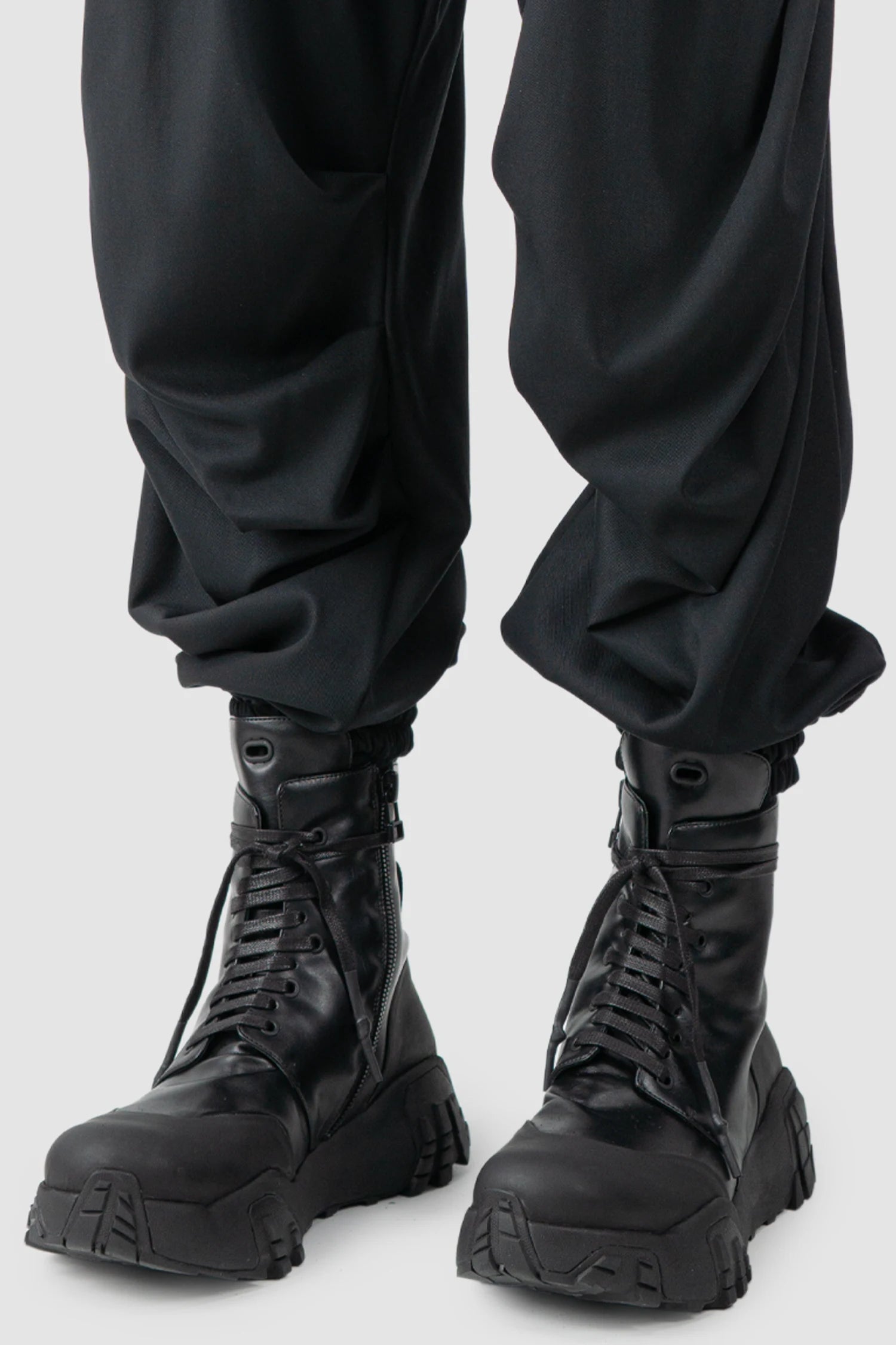 La Haine Inside Us - hem detail view of men’s Black Fluid Leg Draping Trousers