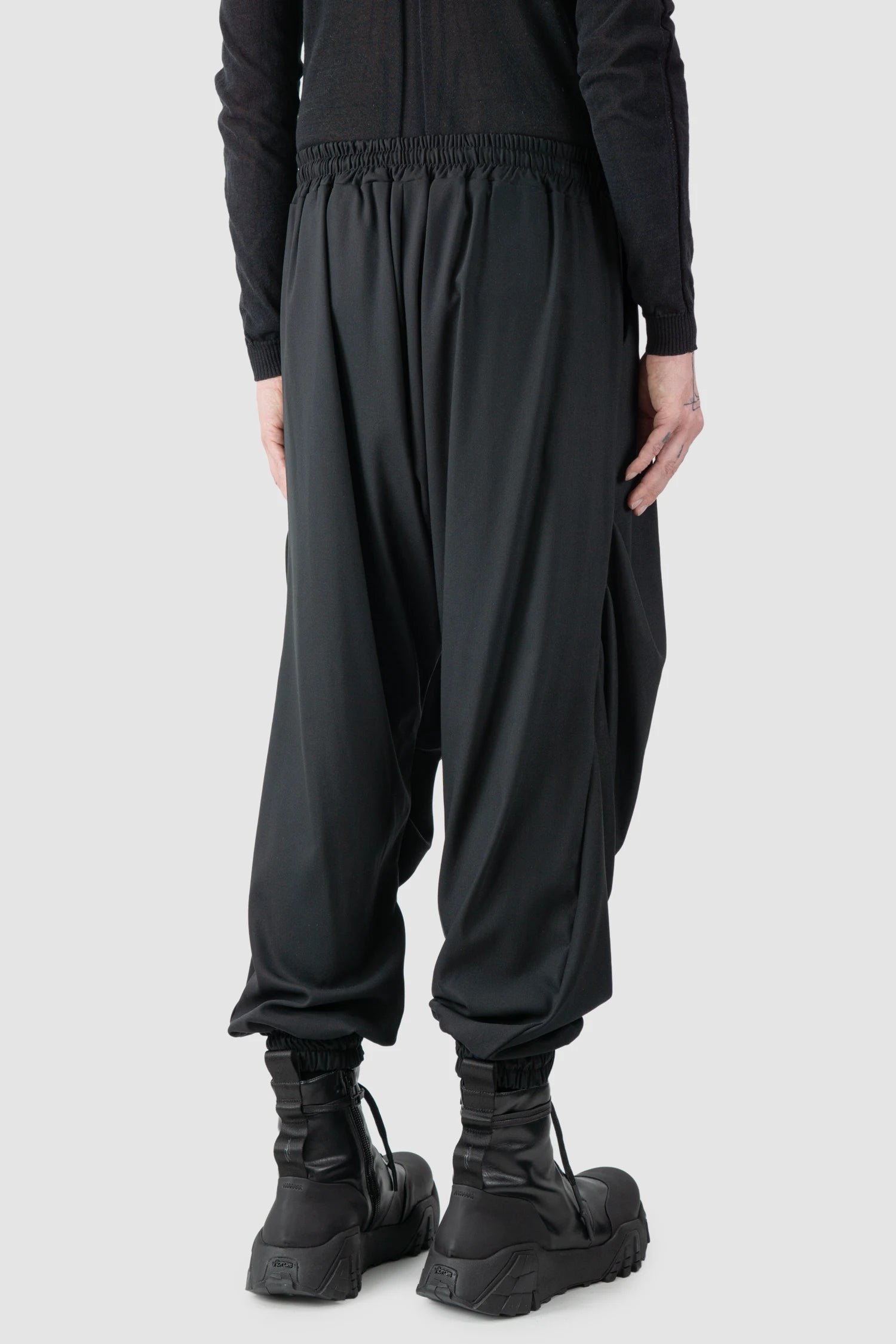 La Haine Inside Us - model back side view of men’s Black Fluid Leg Draping Trousers