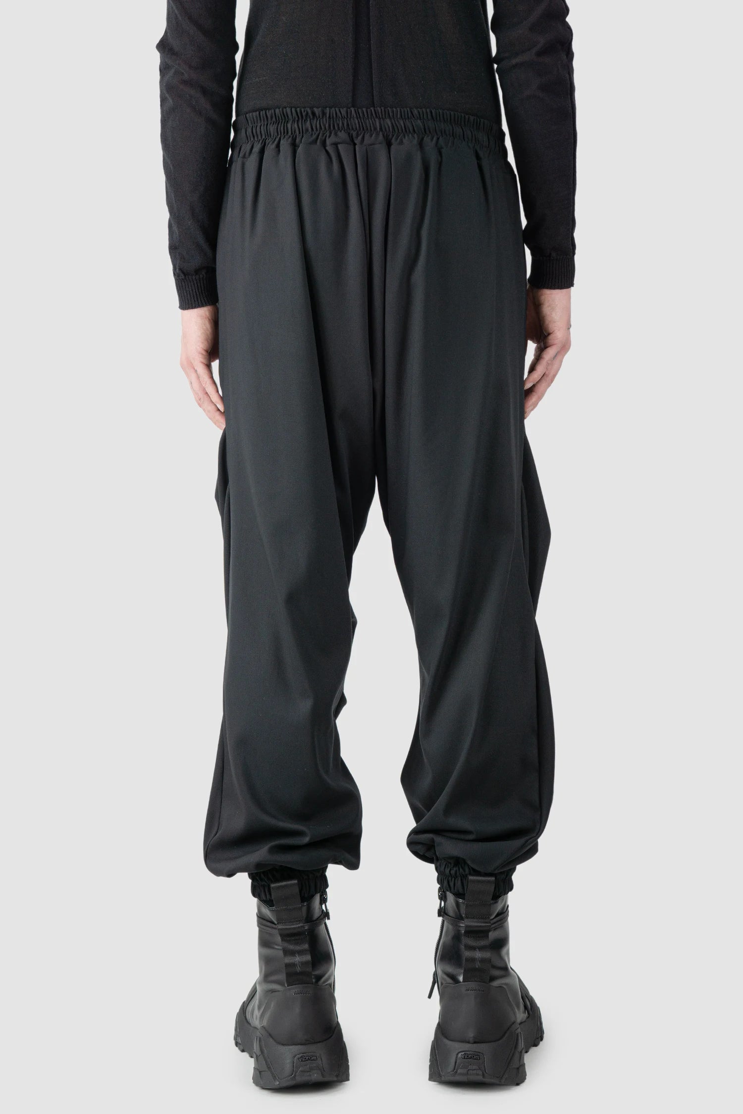 La Haine Inside Us - model back view of men’s Black Fluid Leg Draping Trousers
