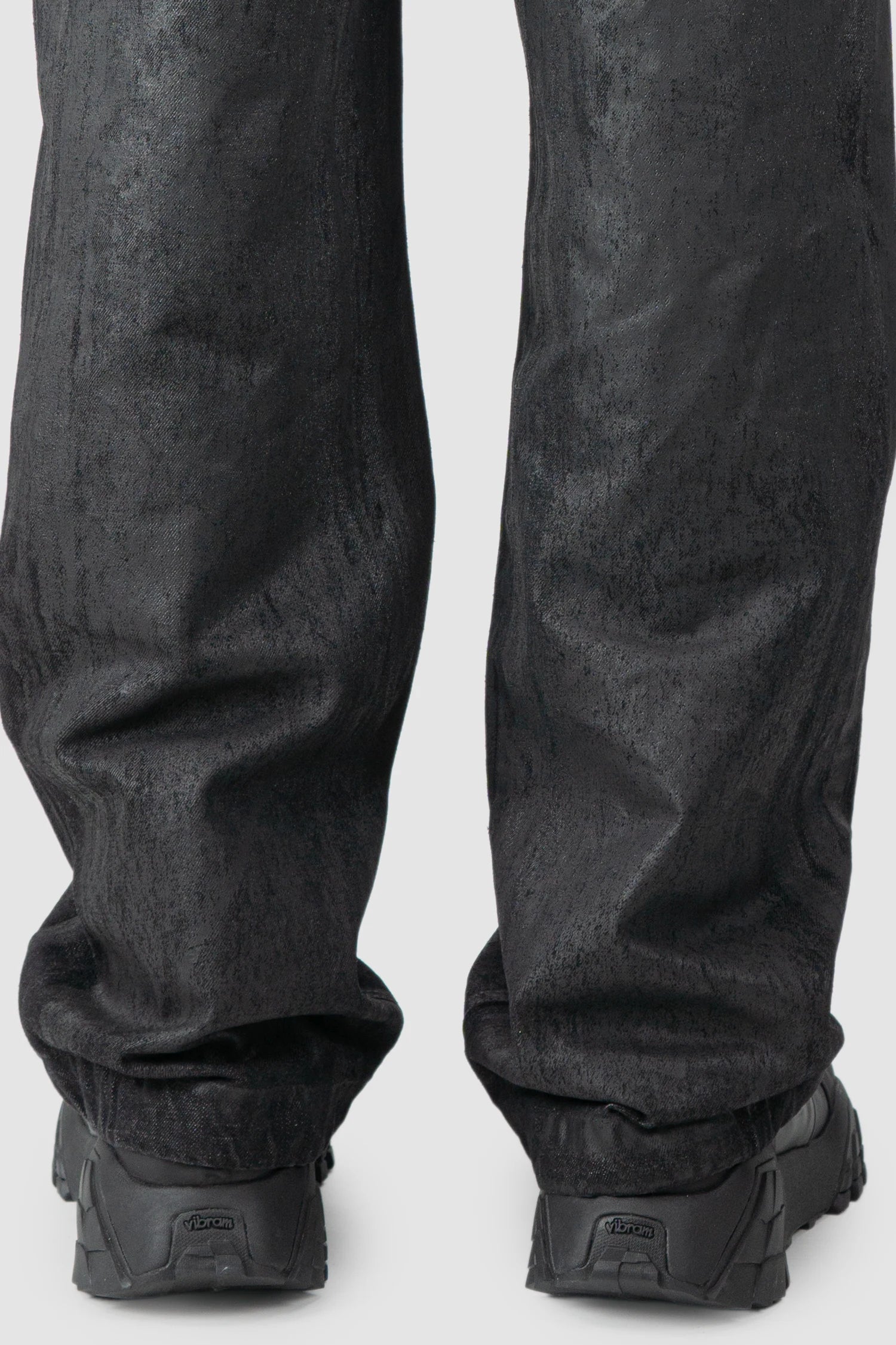 La Haine Inside Us - hem detail view of men’s Black Hand-Painted Rubberized Coated Denim Jeans