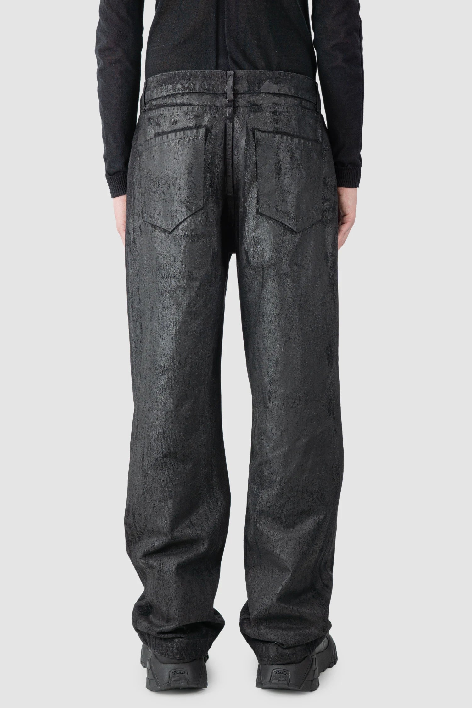 La Haine Inside Us - model back view of men’s Black Hand-Painted Rubberized Coated Denim Jeans